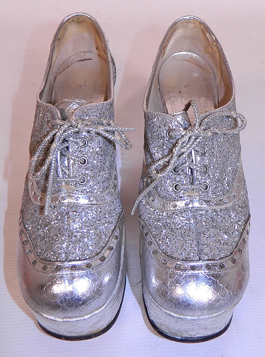 Vintage Di Orsini Silver Glitter Snakeskin Disco Platform Shoes. The shoes measure 11 inches long, 3 inches wide, with a 2 inch front lift and 6 1/2 inch high wedge heel. 