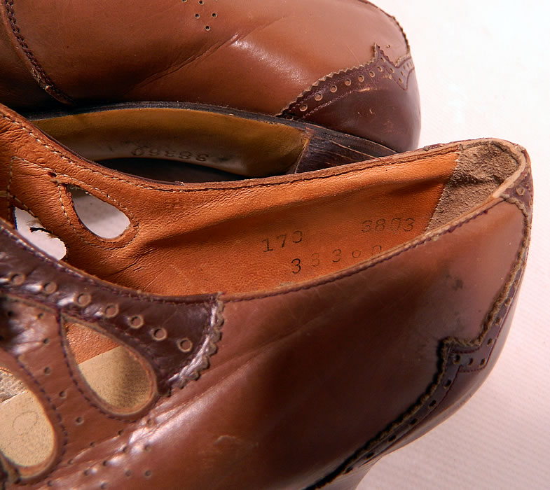 Vintage Two Tone Punchwork Brown Leather Buckle Strap Mary Jane Shoes. They are stamped on the bottom soles and insides with "38360". The shoes measure 10 1/2 inches long, 2 3/4 inches wide, with 2 1/2 inch high heels. 
