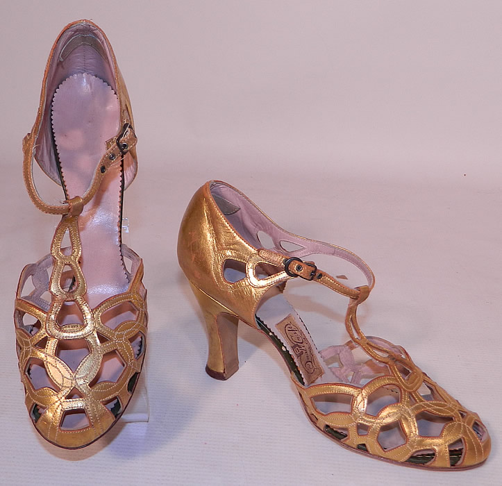 Vintage Quali Craft Art Deco Gold Leather Ring Chain Link Lattice T-Strap Shoes. These elegant evening shoes have a T-strap style, with decorative chain link latticework interlocking circular ring cut out peek-a-boo designs on the front instep vamps toes, with adjustable ankle straps buckle closures and modified boulevard high heels.