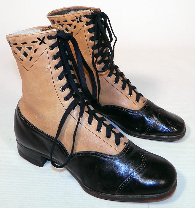 Edwardian Black & Tan Two Tone Leather Lacing Cutouts High Top Boots Shoes
This pair of antique Edwardian era black and tan two tone leather lacing cutouts high top boots shoes date from 1910. They are made of a two tone color combination of a tan leather upper boot and black patent leather lower shoe, with whip stitch lacing decorative cutouts and punch work trim edging.