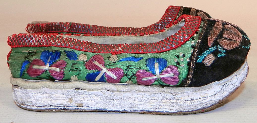 Antique Chinese Forbidden Stitch Embroidered Bound Foot Slippers Platform Shoes
For over a thousand years Chinese women's beauty was judged by the size of their feet which the ideal foot was three inches long and shaped like a lotus bud flower.