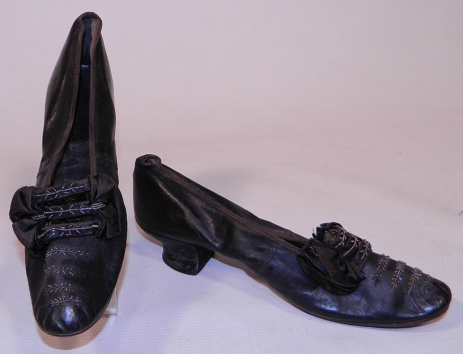 Victorian Black Leather Silk Bow Steel Cut Beaded Louis XV Heel Shoes
These beautiful beaded ball room dancing elegant evening shoes have a slip on slipper style, with a 2 inch high leather covered French Louis XV heel and rounded toes.