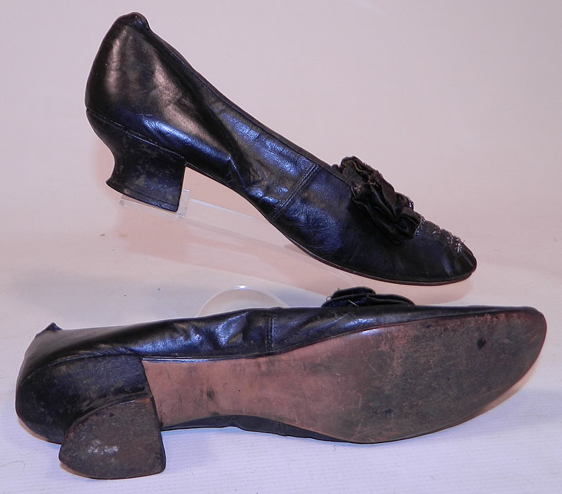 Victorian Black Leather Silk Bow Steel Cut Beaded Louis XV Heel Shoes
The shoes measure 10 inches long and 2 1/2 inches wide. 