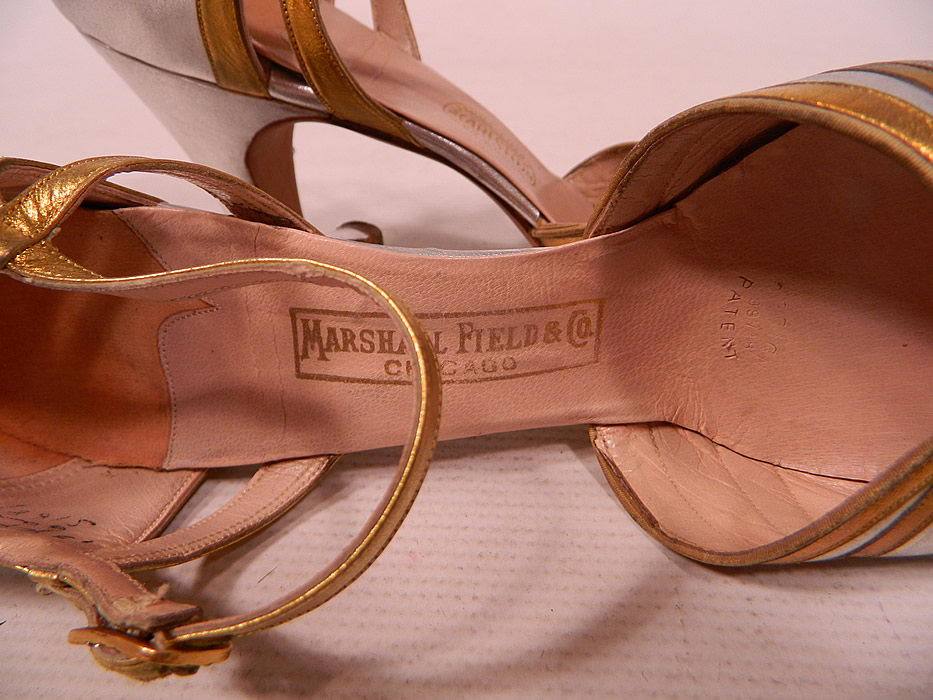 Vintage Marshal Field & Co Aristo Art Deco Silver Gold Leather Ankle Strap Evening Shoes
The shoes measure 9 1/2 inches long, 2 1/2 inches wide, with 3 inch high heels and are stamped inside a size 6 AA. 