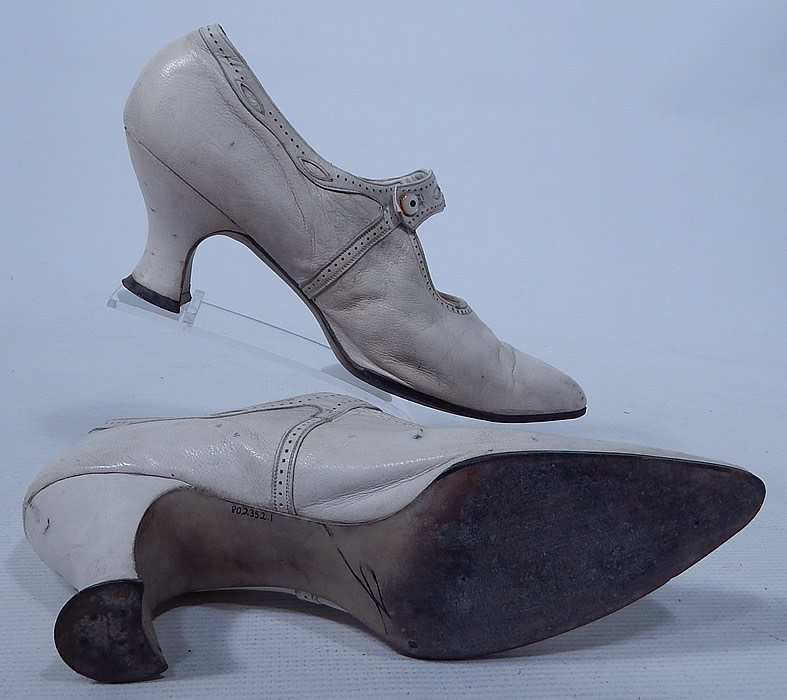 Edwardian Vintage H.H. Tuttle Co. White Leather Button Strap Mary Jane Shoes
The shoes measure 11 inches long, 3 inches wide, with a 3 inch high heel. They are approximately a size 7 or 7 1/2 narrow width. The shoes have been gently worn and are in good condition, with only some slight wear and scuff marks. These are truly beautiful quality made shoe!