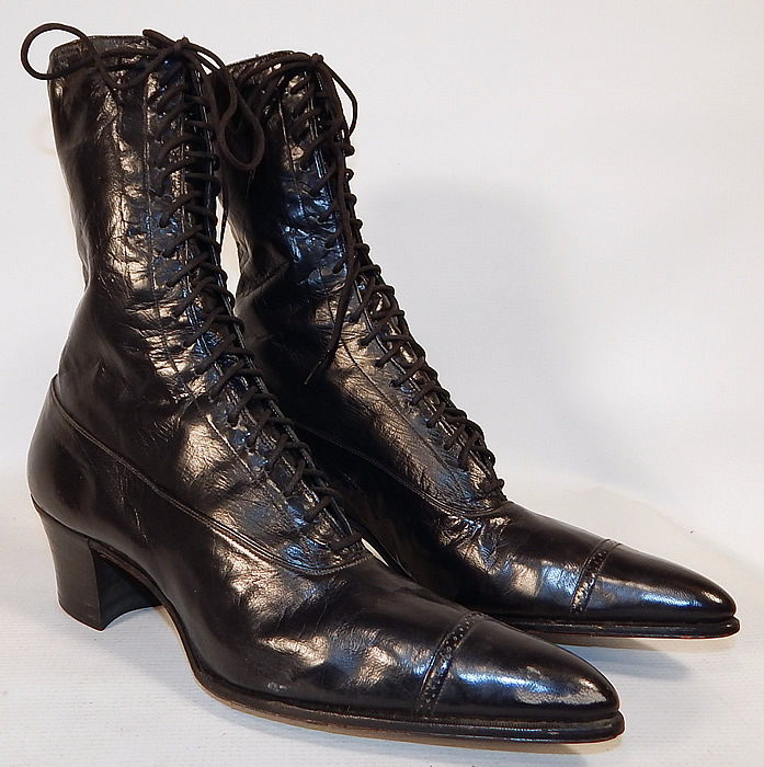 Unworn Victorian Black Leather High Top Lace-up Boots Poehlman Shoe Co.
They are made of a supple black leather, with decorative punch work designs on the toes.