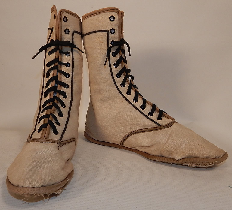 Edwardian Ecru Cream Cotton Canvas Sporting Swim Shoes Bathing Boots
The shoes measure 8 inches tall, 9 1/2 inches long and 2 1/2 inches wide. They are in good, as-is condition, with some wear, fraying along the bottom sole edging, a few faint tiny age spot stains and the shoe laces have been replaced with shorter ones.