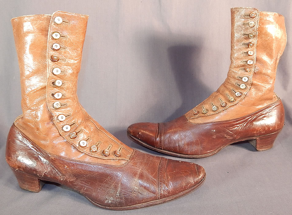 Victorian Antique Brown Two Tone Leather High Top Button Boots Shoes
These beautiful boots have pointed toes, decorative punchwork designs across the toes, the original 15 pearlescent light brown color shoe buttons for closure and stacked wooden cube heels.