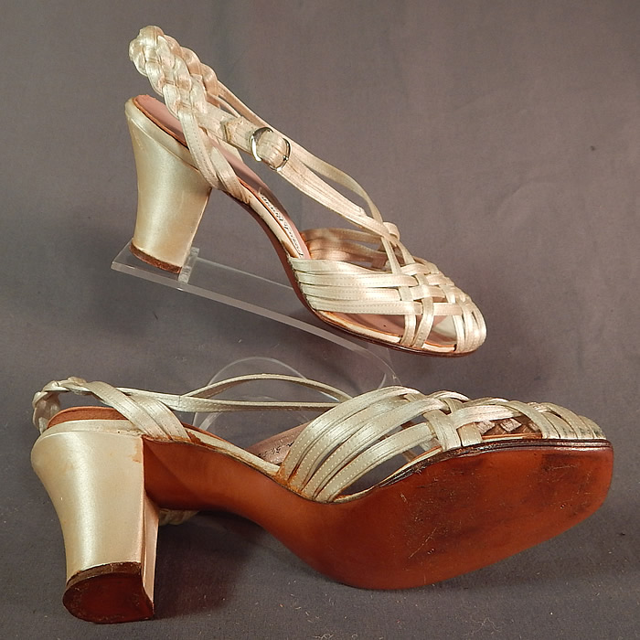 Vintage Chandlers French Room Silk Braided Woven Strap Bridal Wedding Shoes
These beautiful bridal wedding shoes have a sheer sandal style with open toes, peekaboo side openings, an adjustable silver buckle side strap closure, braided back strap and satin covered cube high heels. 