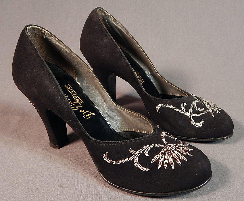 Vintage De Sylvi Creation Hand Painted Black Suede Leather Rhinestone Beaded Shoes
hey are made of a black suede leather, with raised hand painted silver floral leaf decorative designs accented with silver studded rhinestone beadwork on the front toes and heels.