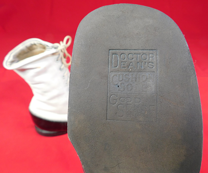 Unworn Vintage Doctor Deans Edwardian Two Tone Black & White Leather High Top Boots
These youth child size beautiful boots have rounded bulbous toes with decorative punch work designs, the original white shoe string laces for closure, a low stacked wooden black heel and are stamped on the bottoms "Doctor Dean's Cushion Sole Good Sense Shoe" label. 