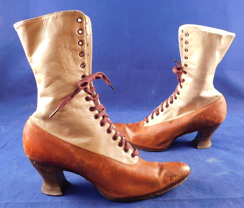 Edwardian BSWU Women's Two Tone Brown Leather High Top Lace-up Boots
This pair of antique Edwardian era BSWU women's two tone brown leather high top lace-up boots date from 1905. They are made of a two tone brown color leather with a lighter beige tan shade on the top. 