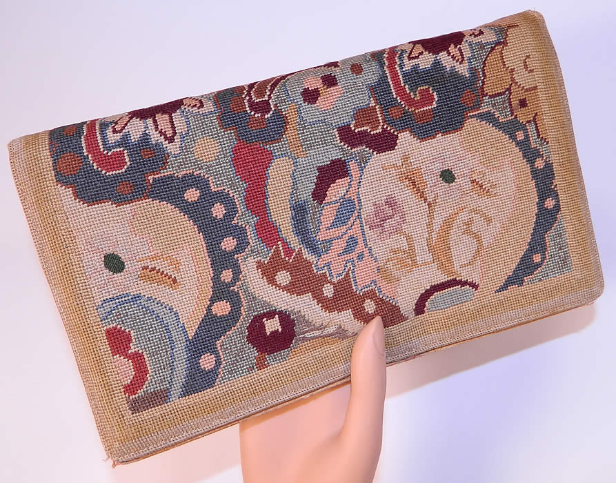 Vintage Art & Crafts Floral Petit Point Needlepoint Embroidered Clutch Bag Purse. It is made of muted colors of petit point needlepoint hand embroidery work done in an Arts & Crafts abstract floral design pattern. This pretty purse has a clutch envelope style, with a fold over flap snap closure, silk lined with an inside zipper pocket and attached coin purse.