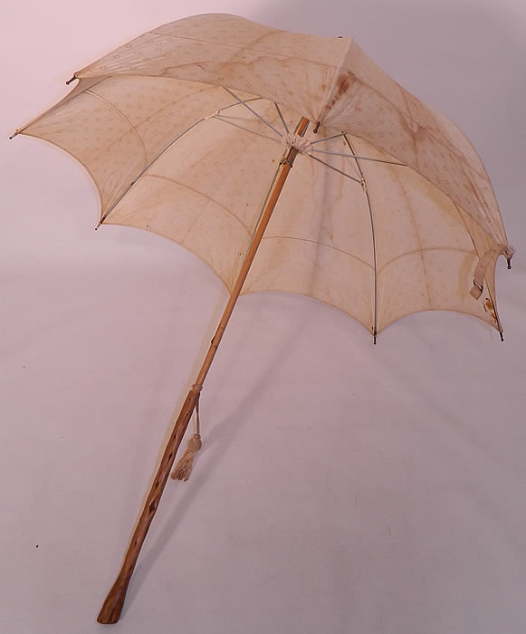 Edwardian Polka Dot Linen Burl Wood Handle Summer Pagoda Parasol. There is a natural burl wood handle and wooden finial top with gathered scrunchie fabric trim. This pretty parasol summer umbrella has a pagoda dome shape, with metal frame inside, original button strap for keeping closed and ecru tassel trim. 