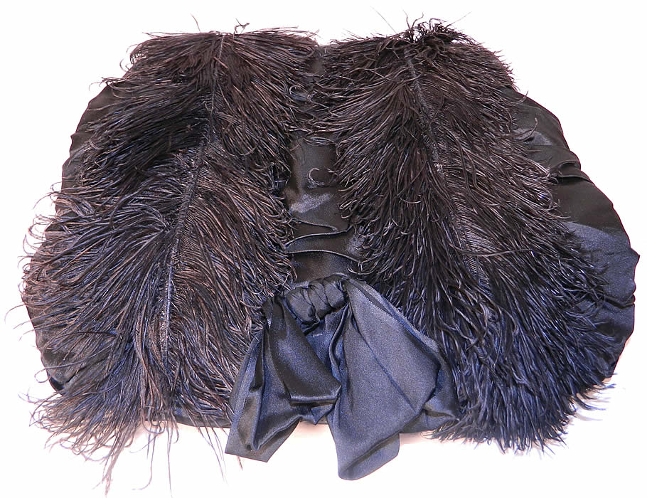 Victorian Black Silk Ostrich Feather Plume Trim Winter Muff Hand Warmer.It is made of a black silk satin fabric with smocking, gathering, bow trim and covered with black ostrich feather plumes.