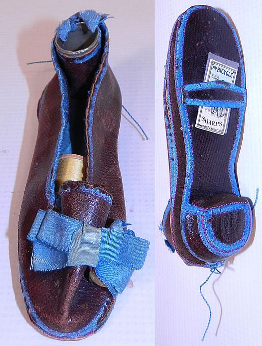 Antique Victorian Sewing Shoe Etui Needle Case Thimble Holder. This antique Victorian era sewing shoe etui needle case thimble holder dates from the 1860s. It is hand stitched, made of brown leather with blue silk trim edging, bow accents on the front instep vamp and back heel. 