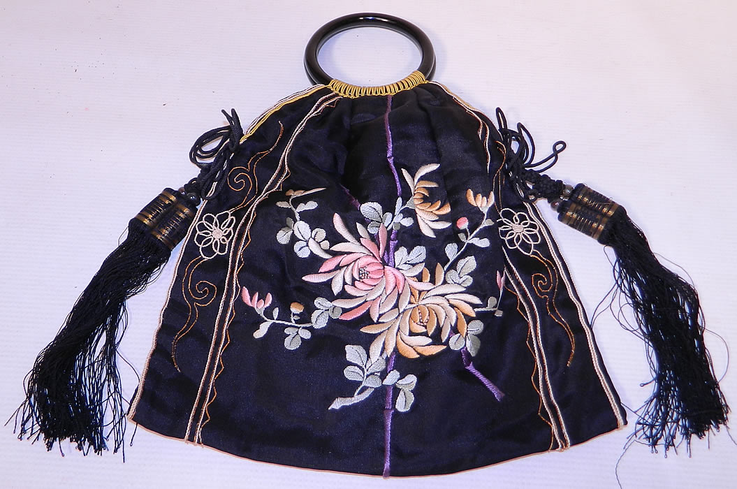 Antique Chinese Silk Embroidered Spider Chrysanthemum Tassel Purse. This antique Chinese silk embroidered spider chrysanthemum tassel purse dates from the 1920s. It is made of a black silk fabric, with colorful pastel silk raised padded satin stitch and gold metallic thread couching hand embroidery work. 
