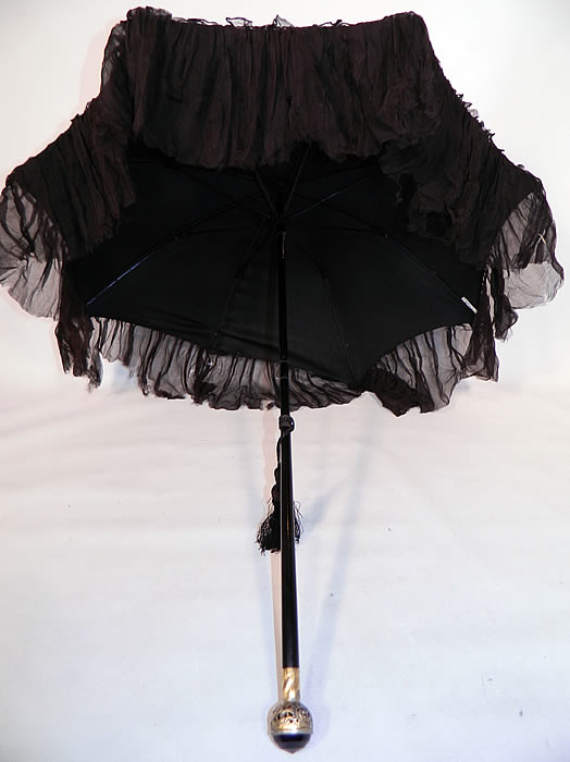 Edwardian Black Silk Ruched Ebony Amethyst Jeweled Handle Parasol. It is in good  condition, with only the fabric loose on one spoke tip needing attaching and some fraying along the bottom silk ruffle trim. This is truly a wonderful antique bejeweled elegant parasol!