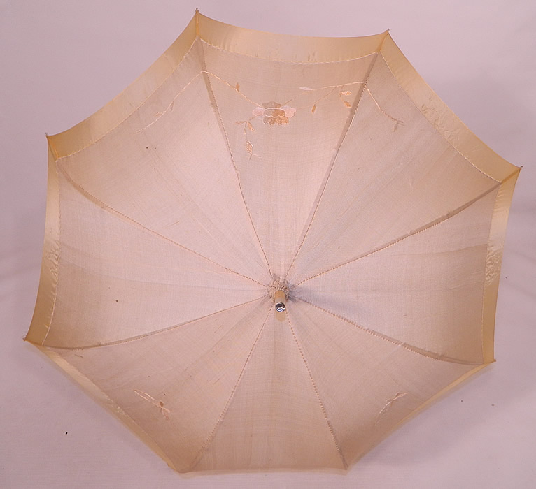 Edwardian Ecru Cream Silk Embroidered Folding Wood Handle Pagoda Parasol. There is a unique folding wood handle with brass chain link mechanism, wood and metal capped tip finial top with gathered scrunchie fabric and silk tassel trim.