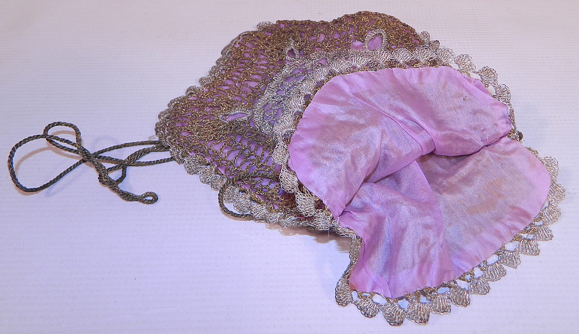 Vintage Gold & Silver Lamé Lame Crochet Lace Reticule Flapper Bag Purse. This fabulous flapper bag reticule style small pouch purse has a gold bullion rope cord drawstring closure at the top and is fully lined in a lavender purple silk lining inside. The purse measures 9 inches long and 7 inches wide. It is in good condition. This is truly a wonderful piece of antique textile lace art!