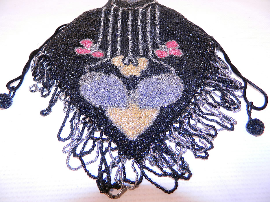 Vintage Art Deco Black & Silver Beaded Fringe Drawstring Flapper Purse
There is a silver & black loop fringe trim hanging down from the bottom.