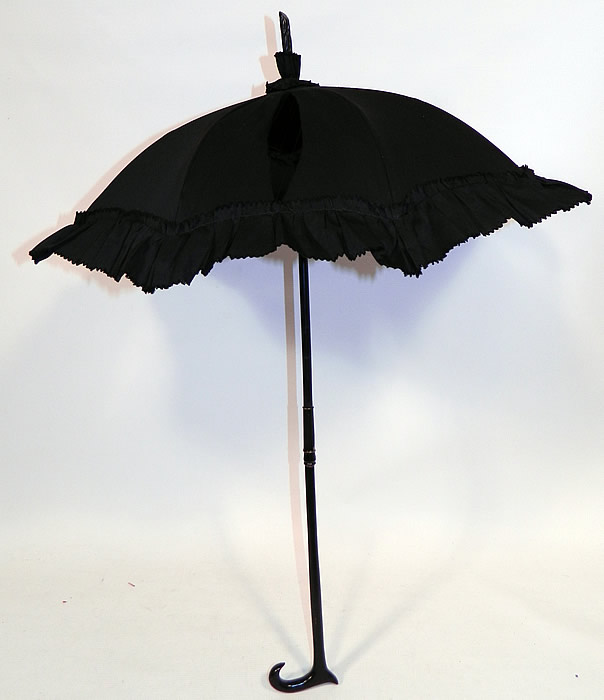 Victorian Civil War Black Silk Ebony Folding Handle Marquis Mourning Parasol
This antique Victorian Civil War era black silk ebony folding handle marquis mourning parasol dates from the 1860s.