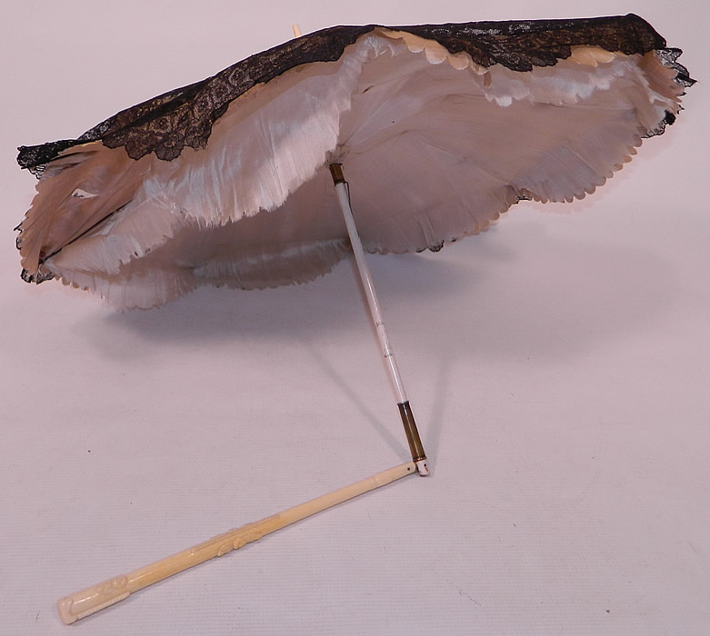 Victorian Civil War Antique Black Chantilly Lace Carved Roses Folding Handle Parasol
The parasol measures 27 inches long extended, 15 inches long when folded and the fabric outside is 72 inches in circumference when opened up. 