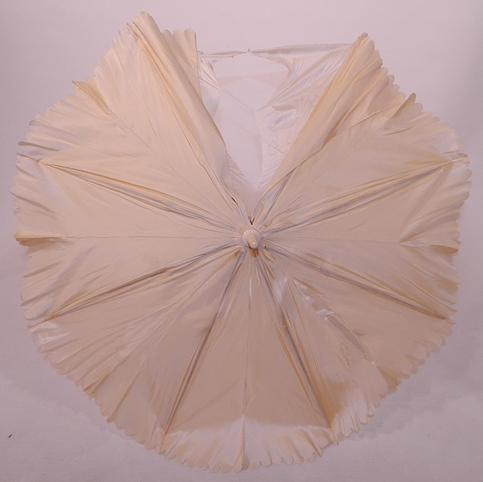 Victorian Cream Silk Carved Chain Link Wrapped Handle Parasol Tassel Trim
It is lined in a white silk fabric. The parasol measures 26 inches long and is 72 inches in circumference when opened up. It is in as-is fair condition, with several splits in the outer silk fabric and inside lining (see close-up). This is truly a wonderful wedding parasol which could be recovered and is in fine working order! 