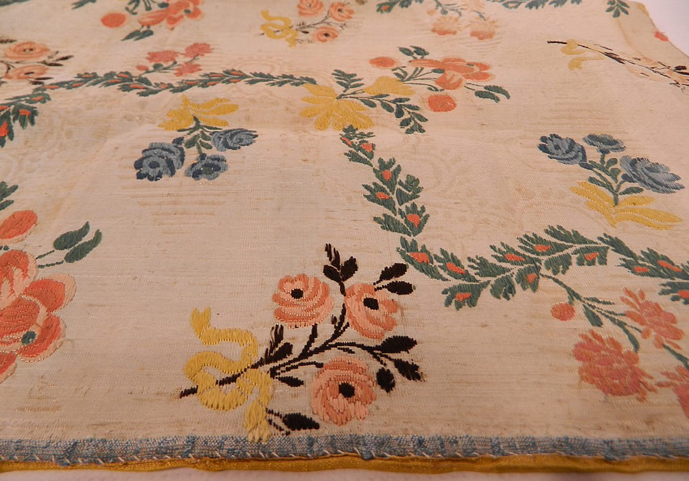Antique 18th Century French Silk Damask Brocade Dress Fabric Remnant Square
It is hand stitched, made of a colorful woven silk damask brocade French fabric with a floral vine leaf pattern weave design, blue selvage trim edging along one side and is fully lined backed in a gold silk fabric.