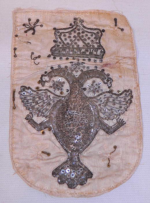 Antique 18th Century Silver Stumpwork Beaded Heraldic Heraldry Coat of Arms Russia
This antique silver stumpwork beaded heraldic heraldry coat of arms Russia dates from the 18th century. It is hand stitched, made of a white silk fabric with three dimensional raised silver bullion stumpwork embroidered decorations and silver metal sequin beaded accents.