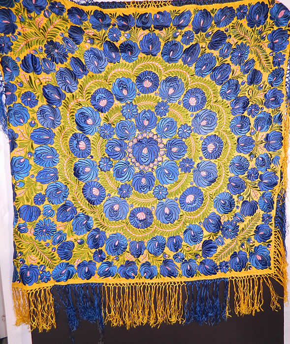 Antique Matyo Hungarian Folk Embroidery Fringe Large Square Shawl Tablecloth
There is a floral vine leaf design densely embroidered onto the fabric in a circular pattern, with hand knotted two tone yellow and blue silk fringe trim edging. The embroidery work is exquisitely done with wonderful workmanship.