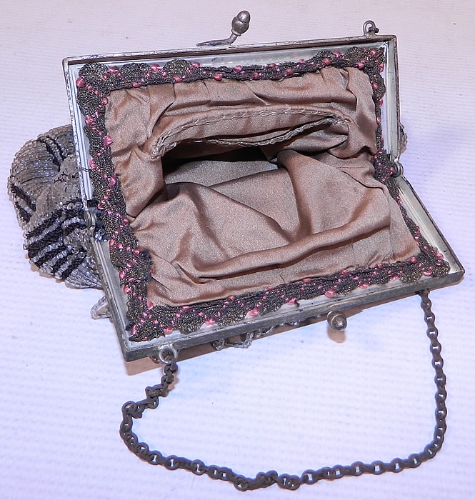 Vintage Art Deco Black Knit Crystal Beaded Loop Fringe Silver Frame Flapper Purse
The purse measures 8 1/2 inches long and 6 1/2 inches wide. It is in excellent condition, with no loose or missing beads. This is truly a wonderful piece of antique beaded textile art!