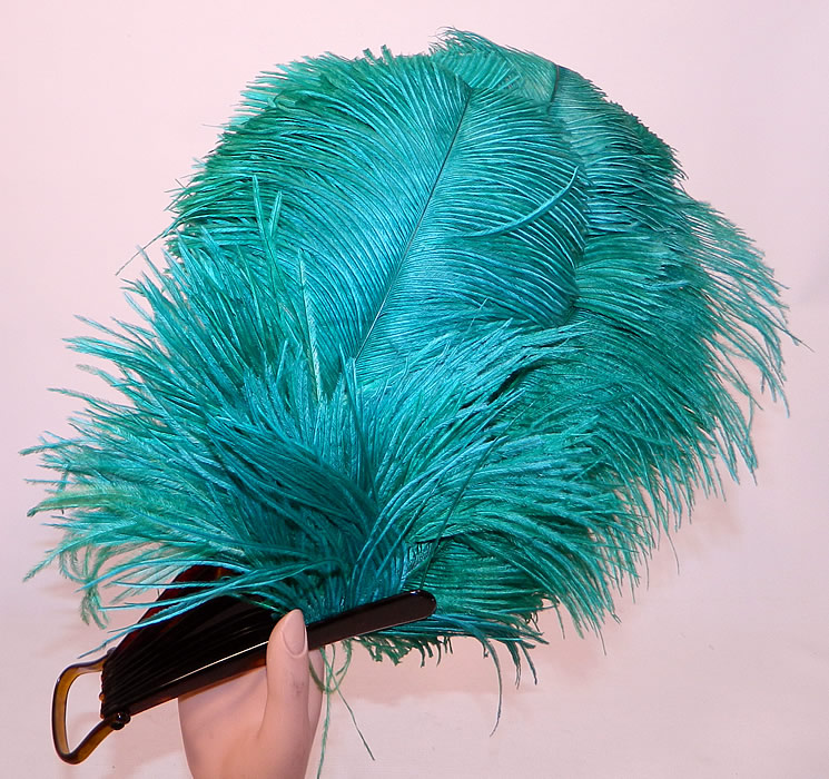 Vintage Art Deco Teal Blue Green  Ostrich Feather Folding Flapper Fan
There are faux tortoise shell celluloid sticks, guards and loop rivet on the bottom.
