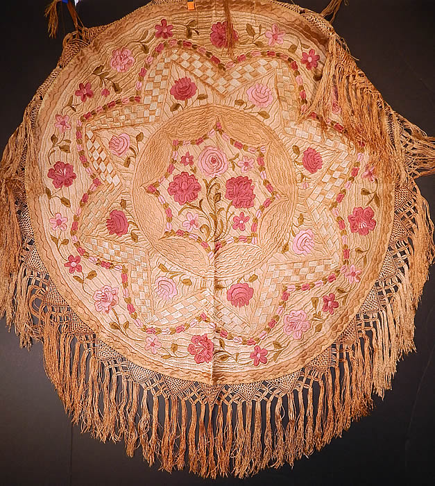 Antique Matyo Hungarian Folk Embroidery Pink Floral Fringe Round Tablecloth
This antique Hungarian Matyo folk embroidery pink floral fringe round tablecloth dates from the 1920s. It is hand stitched, made of varying shades of pinks, ecru beige and green silk threads done in raised padded satin stitch Matyo embroidery work completely covering the entire linen fabric. There is an eight point star design in the center, checkered, scalloped patterns, with a floral vine leaf design densely embroidered onto the fabric in a circular pattern and hand knotted macrame silk fringe trim edging.