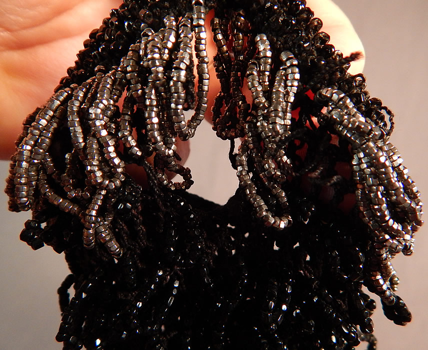 Vintage Art Deco Black Crochet Jet Silver Steel Cut Beaded Drawstring Flapper Purse
The purse measures 7 inches long and 3 inches wide. It is in good as-is condition, with a small frayed hole near the top (see close-up). This is truly a wonderful piece of antique Art Deco beaded textile art! 