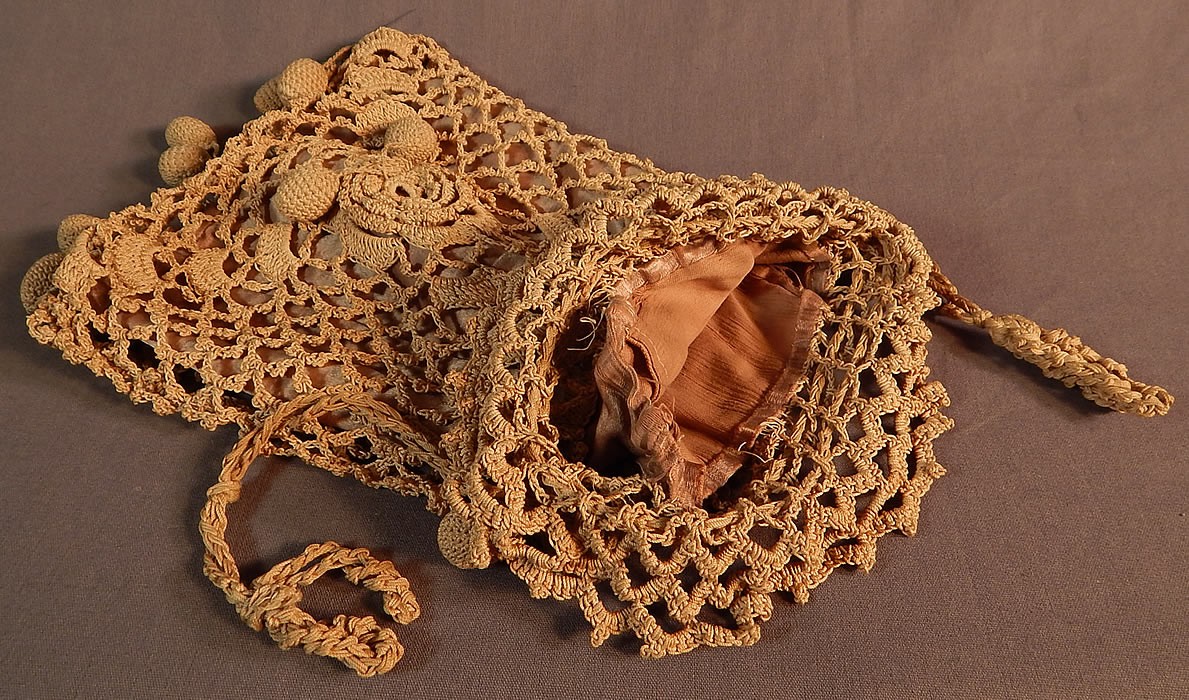 Edwardian Ecru Crochet Lace Ball Tassel Fringe Drawstring Pouch Purse Bag
This lovely lace ladies pouch purse has a drawstring bag style, with knotted rope carrying straps gathered on the top and is lined in a beige silk satin fabric inside. The purse measures 11 inches long and 7 inches wide.