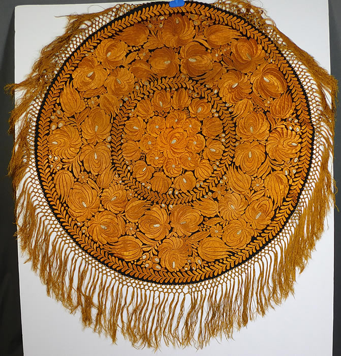 Antique Matyo Hungarian Folk Embroidery Yellow Floral Fringe Round Tablecloth
This antique Hungarian Matyo folk embroidery yellow floral fringe round tablecloth dates from the 1920s. It is hand stitched, made of golden yellow silk threads done in raised padded satin stitch Matyo embroidery work completely covering the entire black linen fabric underneath.